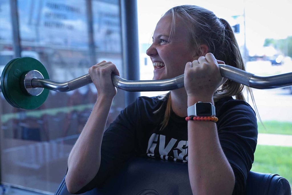 A female High School Athlete having fun working out